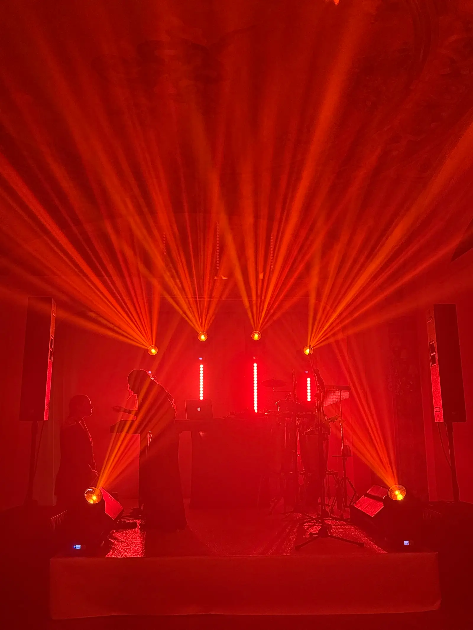 Band dal vivo sul palco, luci rosse